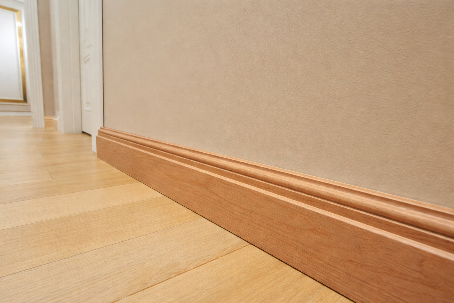 Unpainted base moulding installed along wall.