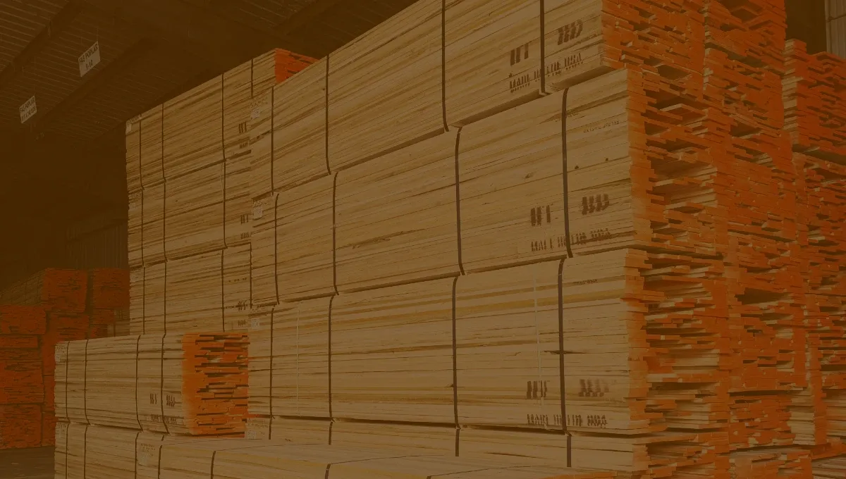 Hardwood lumber products stacked in warehouse.