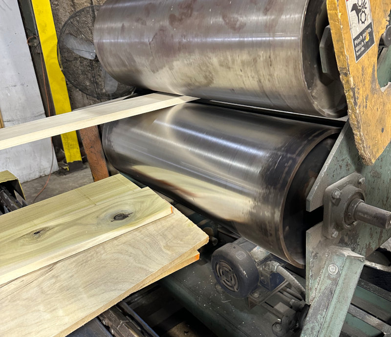 Lumber going through ther straight line rip.